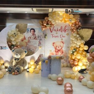 Teddy theme first birthday stage decoration with pastel balloons in Bhopal