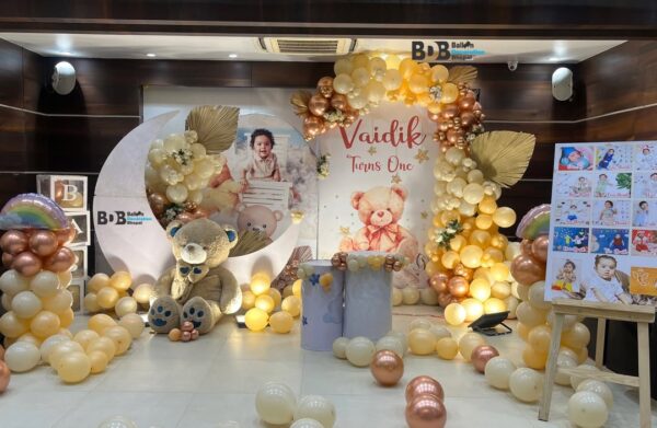 Teddy theme first birthday stage decoration with pastel balloons in Bhopal