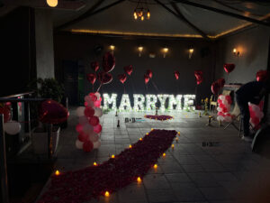 Romantic marriage proposal decoration with name letters candles and heart balloons in Bhopal