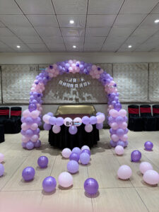 Lavender theme birthday balloon decoration with purple pastel balloon arch in Bhopal banquet hall
