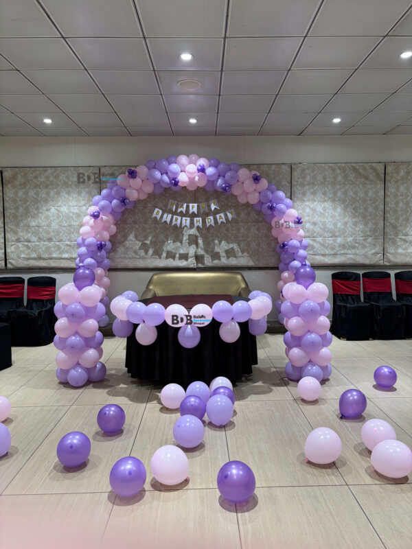 Lavender theme birthday balloon decoration with purple pastel balloon arch in Bhopal banquet hall