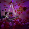 Romantic just married room decoration with red and white balloons and fairy light canopy bed setup in Bhopal