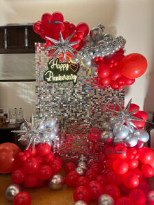 Red and silver anniversary balloon decoration with LED backdrop in Bhopal
