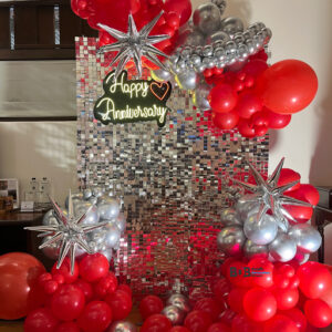 Red and silver anniversary balloon decoration with LED backdrop in Bhopal