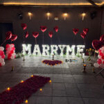 Romantic marriage proposal decoration with name letters candles and heart balloons in Bhopal