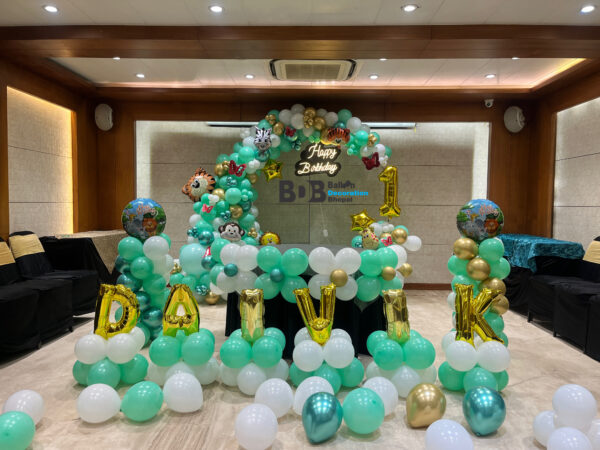 Jungle theme first birthday balloon decoration with name and safari animal balloons in Bhopal
