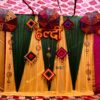 Traditional haldi ceremony decoration with yellow green drapes and ethnic umbrella decor in Bhopal