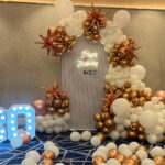 Luxury 30th birthday balloon decoration with white and rose gold balloon arch and LED numbers in Bhopal