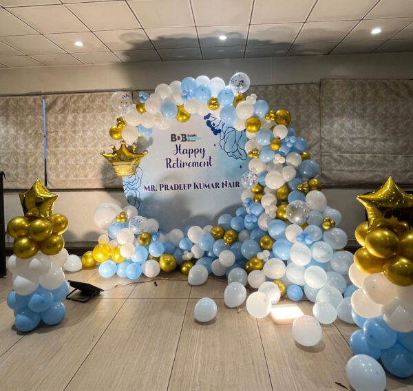 Happy retirement balloon decoration with blue white and gold theme and customized name backdrop in Bhopal