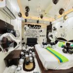 Black and silver birthday surprise room decoration with balloons and happy birthday backdrop in Bhopal