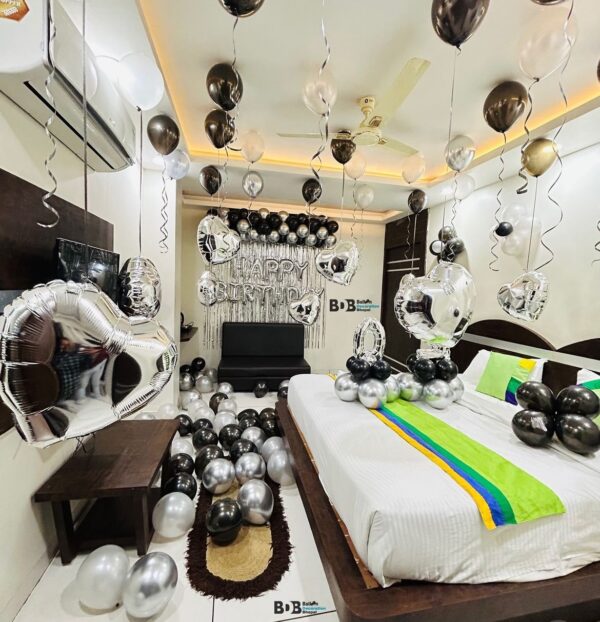 Black and silver birthday surprise room decoration with balloons and happy birthday backdrop in Bhopal