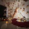 Luxury rose gold romantic couple bedroom decoration with balloons fairy lights and rose petals in Bhopal